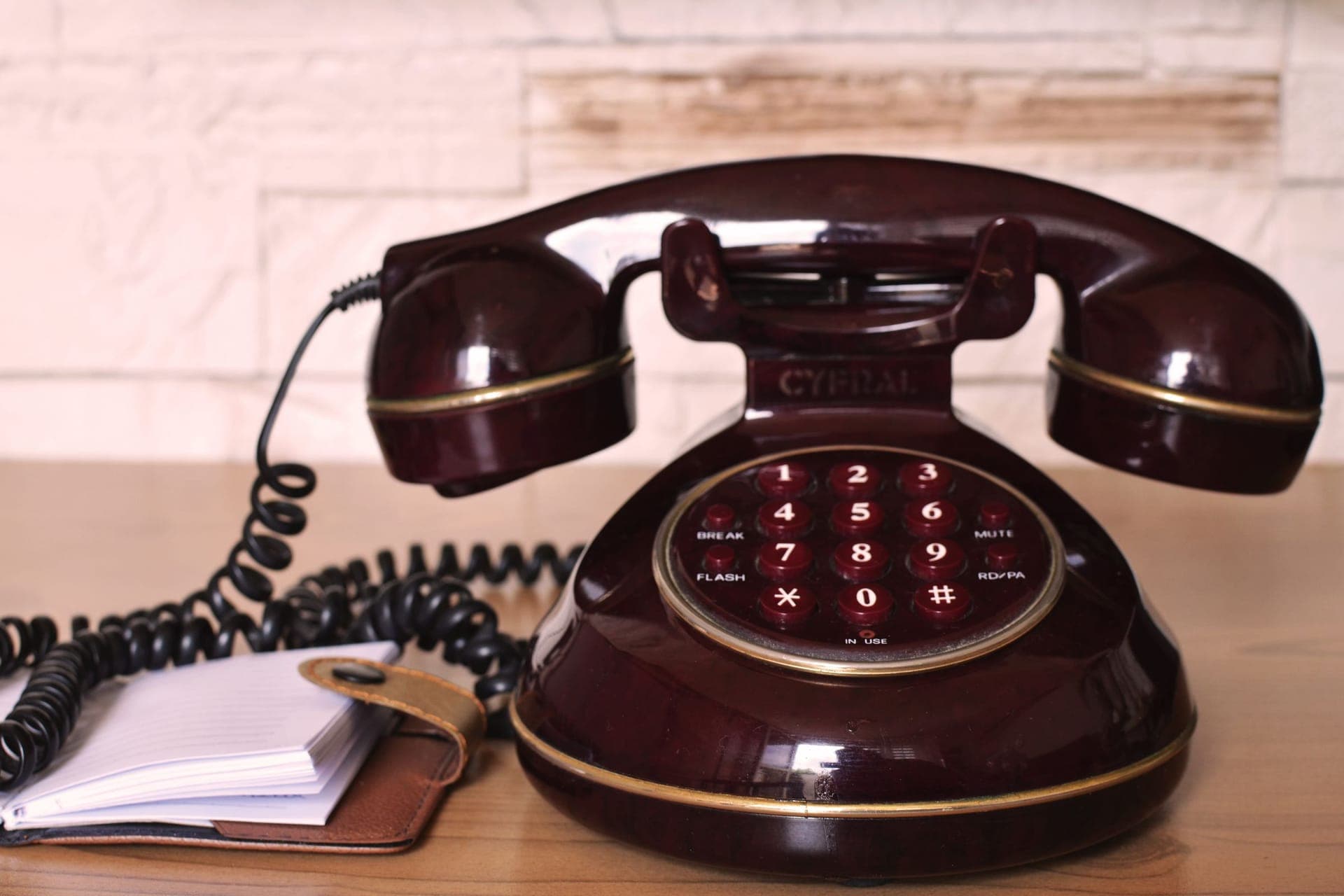 An old desk telephone next to a notepad - the way shops have handled missed calls for decades.